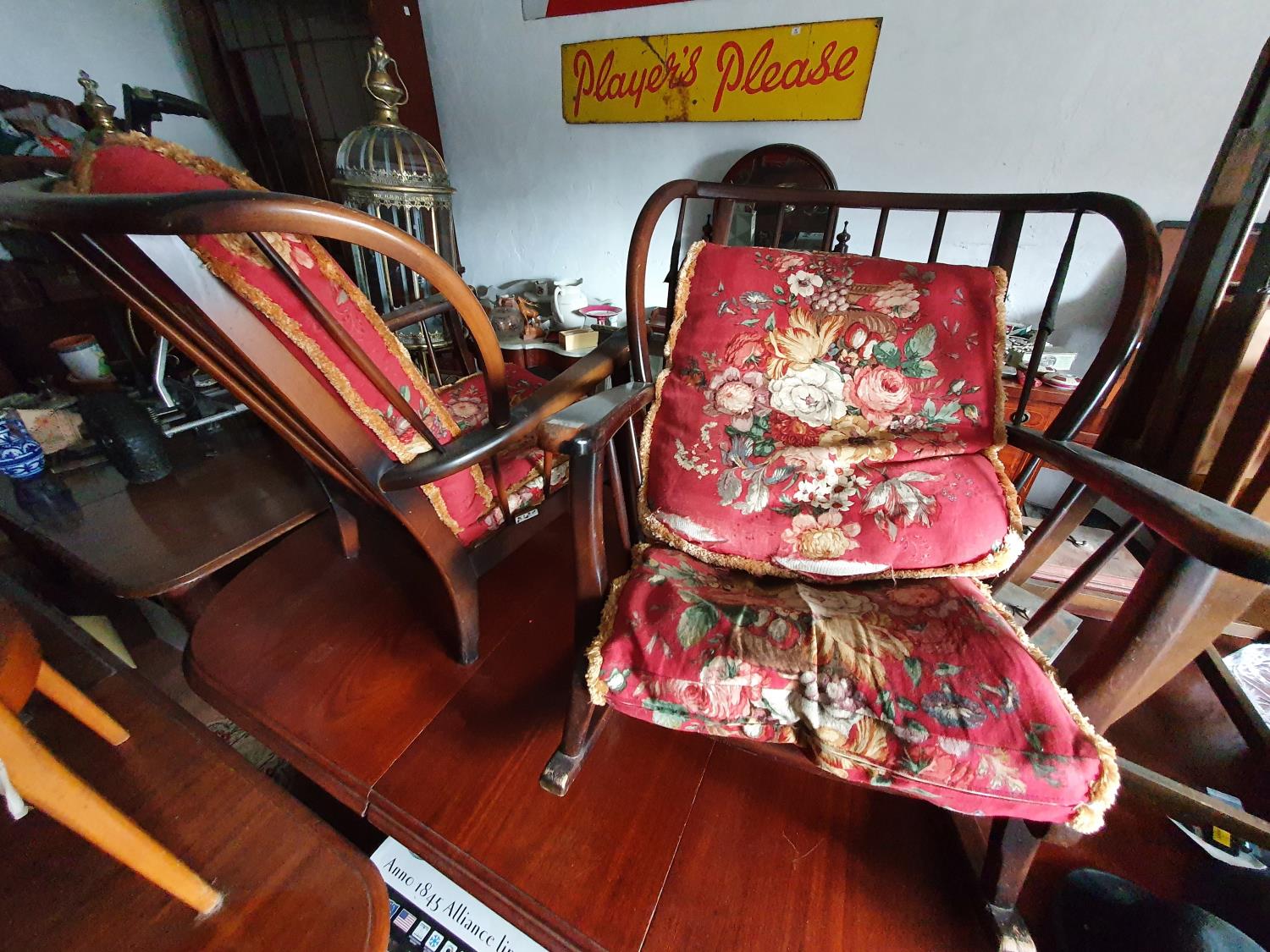 An Ercol style Three Piece Suite consisting of a three seater couch an armchair and a rocking chair.