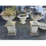 A good pair of reconstituted Stone Urns on Stands. 90 H x 46 cms W