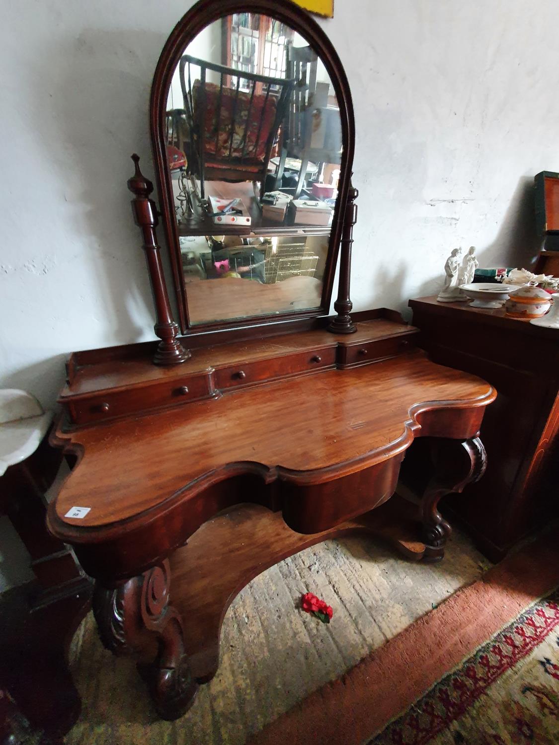 A 19th Century Mahogany Dressing Table with arch top mirror, platform base and cabriole supports