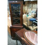 A Mahogany Veneered Corner Cabinet, a Mahogany Hall Table, a centre table and a mirror.