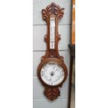 A late 19th early 20th Century carved Oak Aneroid Barometer.