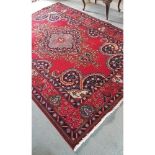 A Persian Red Ground Tabriz Carpet.Size 285 x 198cms.