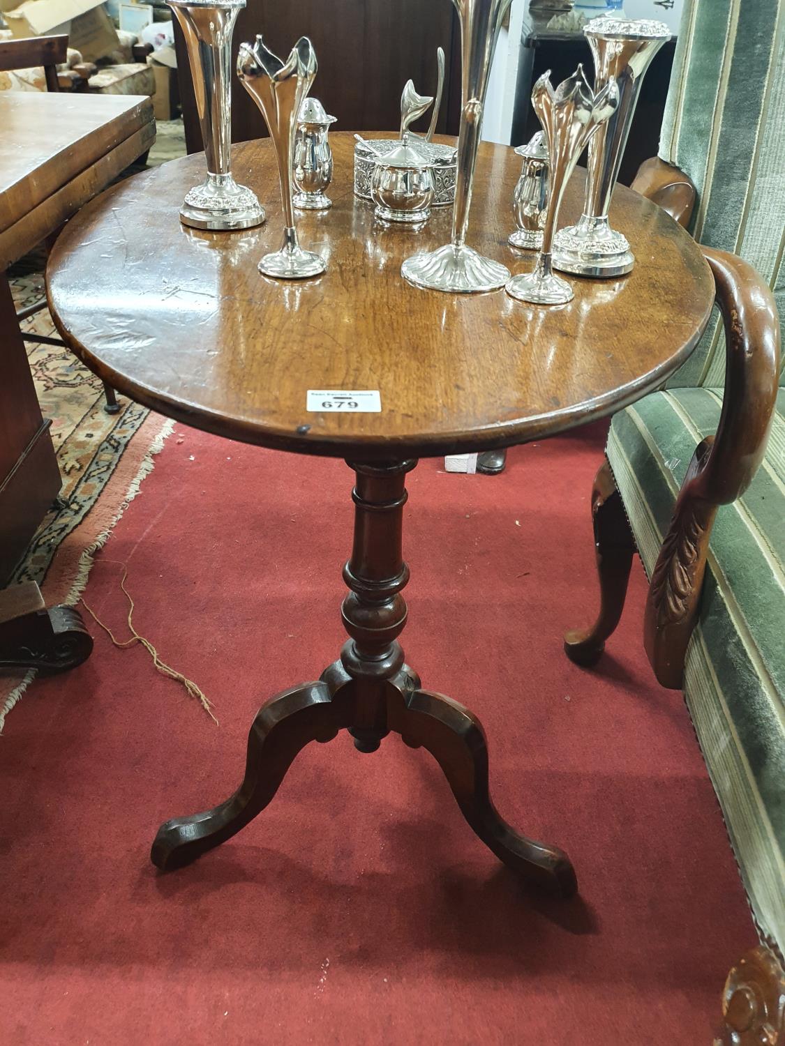 A Georgian Mahogany Oval Supper Table on a tripod base. 68 x 47 cms diam.