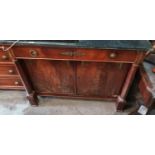 An early 19th Century Mahogany Empire two door Cabinet with ormolu mounts and a black marble top. (