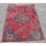 A washed Red Ground Persian Mashad Rug. 285 x 150cm.