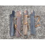 A group of four Leather Quivers each with Arrows.