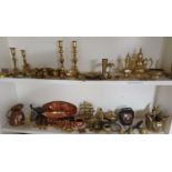 A large quantity of Brass and Copper on two shelves along with a shelf of timber animals.