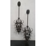 A pair of Metal wall mounted Hanging Lights. 110h cms.