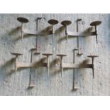 A large quantity of heavy metal Medieval style wall bracket Candle Holders.