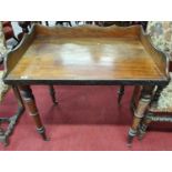 A very rare 18th Century Mahogany Campaign Writing Table on turned detachable supports and a gallery