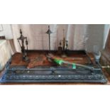 An early 20th Century Steel Fender and another along with a quantity of fireside items and a set