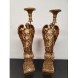 CATHEDRAL SCENE: A pair of Gilded Candlesticks. 62h cms.