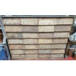 A very large and heavy Timber bank of 28 Drawers with a Metal top.146w x 42d x 111h cms.