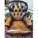 A modern Leather deep buttoned Armchair with turned supports.73w,seat h 44 cms.