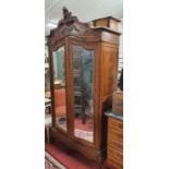 A 19th Century Walnut Armoire with mirrored doors and hanging interior.120w x 45d x 245h cms.
