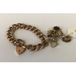 9CT GOLD GATE BRACELET WITH 7 9CT GOLD CHARMS