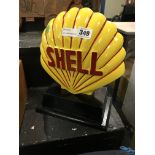 SHELL SIGN ON STAND