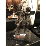 BRONZE OF TWO SEATED CHILDREN