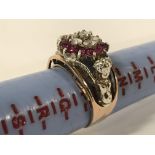 YELLOW & WHITE GOLD DIAMOND & RUBY RING WITH CHERUB SUPPORTS TO SIDE