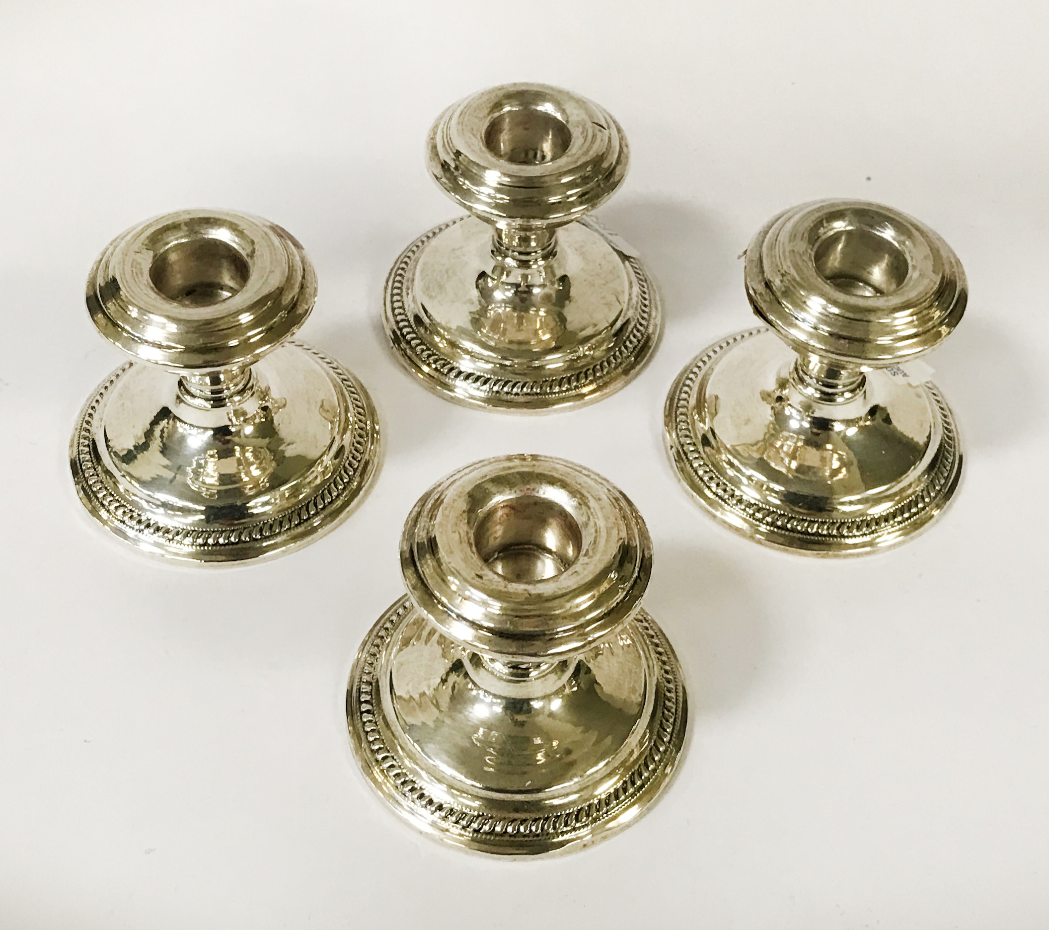 FOUR STERLING SILVER CANDLESTICKS