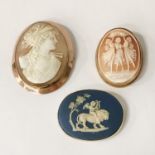 TWO GOLD CAMEO BROOCHES WITH A GOLD WEDGWOOD LION BROOCH RELIEF