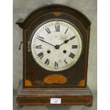 An inlaid mahogany manual wind striking mantle clock