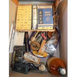 A box of miscellaneous including mahjong set, tape measure, fishing reel, nutcrackers, sharpening