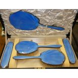 A silver and blue enamel five piece dressing table set, Birmingham 1934, Coronation mark, case