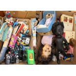 A collection of assorted dolls including a Pedigree plastic black doll, child's clogs, a boxed