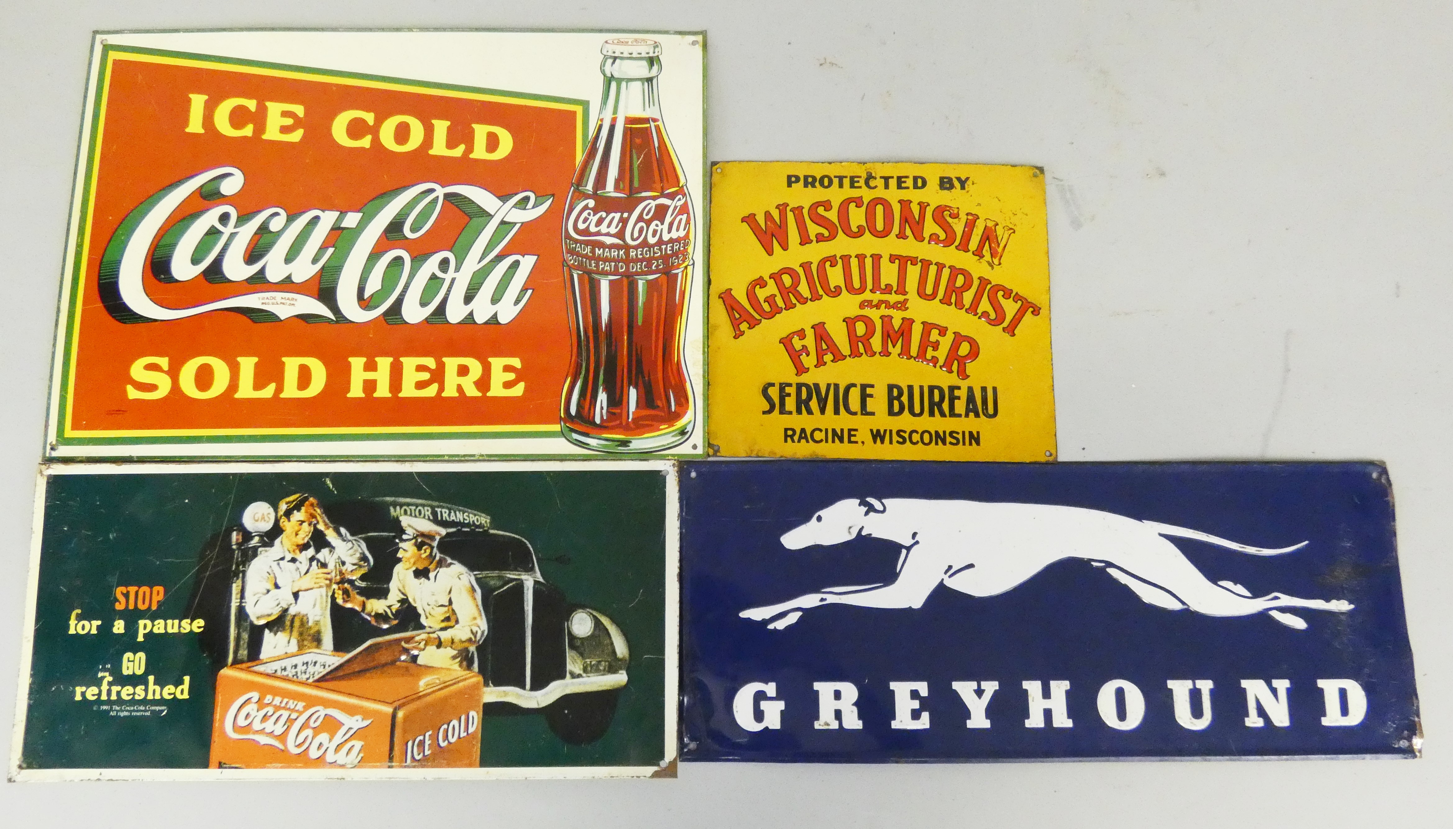 A pressed tin rectangular single sided enamel wall mounted sign for Greyhound, 19 x 47.5cm, together