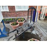 A vintage railway oak and iron luggage hand cart, with iron bound spoked wheels, length 154cm.