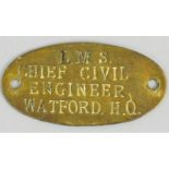 A brass oval plaque 'L.M.S. Chief Civil Engineer Watford H.O.', length 7cm.