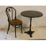 A circular wooden topped cast iron table, together with a Bentwood chair diameter 68cm, height 75cm,