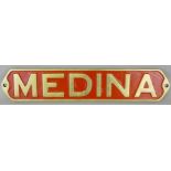 A reproduction brass and red enamel nameplate 'Medina', 55 x 11 cm.