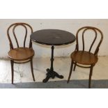 A circular wooden topped cast iron table, together with two Bentwood chairs, diameter 68cm, height