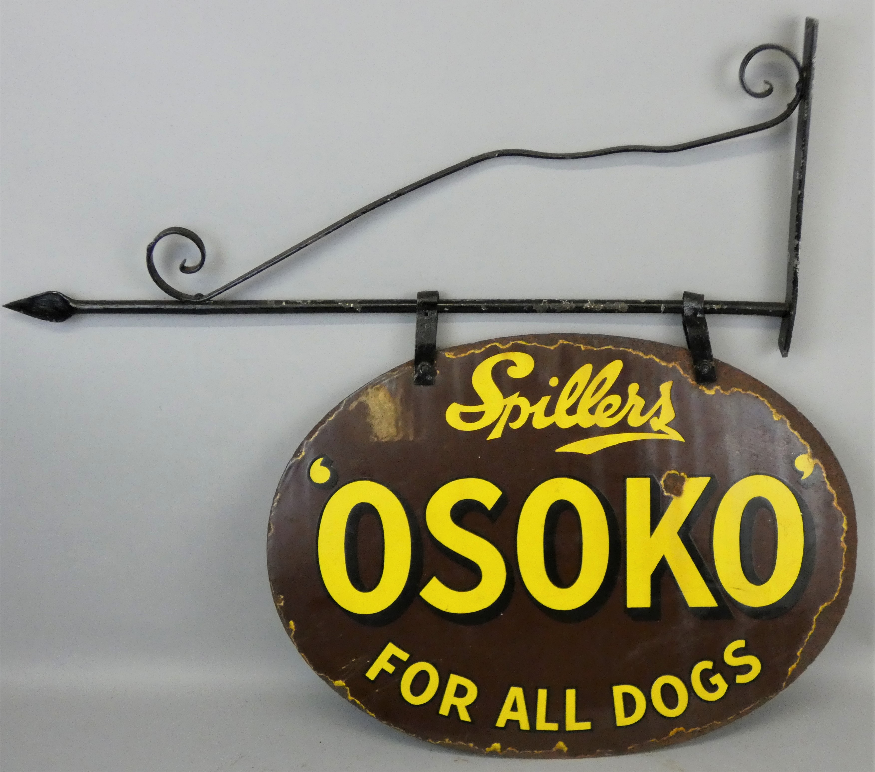 A vintage enamel double sided swinging sign for Spillers Osoko, on original iron hanging bracket,