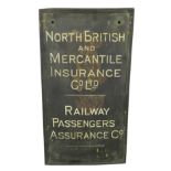 A brass sign 'North British and Mercantile Insurance Co. Ltd, Railway Passengers Assurance Co.',