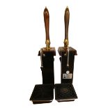 A pair of single line hand-pull beer pumps with brass mounts to wooden handles, mounted on moulded