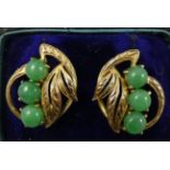 A pair of 14 ct gold and jade earclips, by J.A.W., of scroll form set with cabochon stones, case.