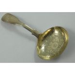 A George III silver fiddle pattern caddy spoon, by James Henry Daniel, London 1804, with floral