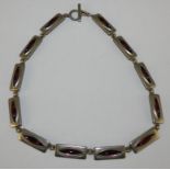 Jorgen Jensen, a pewter and amethyst glass necklace, c. 1960, composed of twelve panels, signed