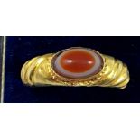 A gold Roman style ring, collet set with a cabochon sardonyx, ribbed tapering shank, size W,