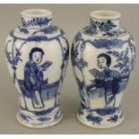 A Chinese pair of blue and white baluster vases, Kangsi four character marks, decorated with a