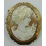 A 9ct gold mounted shell cameo brooch, depicting a lady wearing pearls, 5.5 x 4.5 cm.