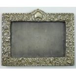 An Edwardian silver photograph frame, Birmingham 1902, with embossed decoration, 11 x 16 cm.