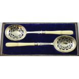 A Victorian pair of ivory handled and electroplated serving spoons, with gilt and pierced bowls,