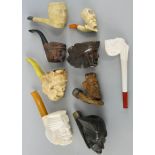 A Meerschaum pipe with amber stem, the bowl depicting a Turk's head, 16 cm, another depicting a