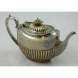 A Victorian silver bachelor tea pot, Sheffield 1893, of half fluted form with ivory finial and