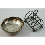 A Victorian silver toast rack, Birmingham 1899, of four division wire form, raised on four ball