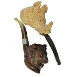A Meerschaum pipe, the bowl depicting a rhinoceros with glass eyes, 15 cm together a briar pipe with